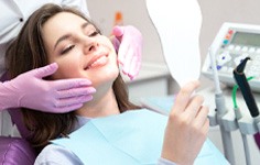 patient smiling in dental mirror